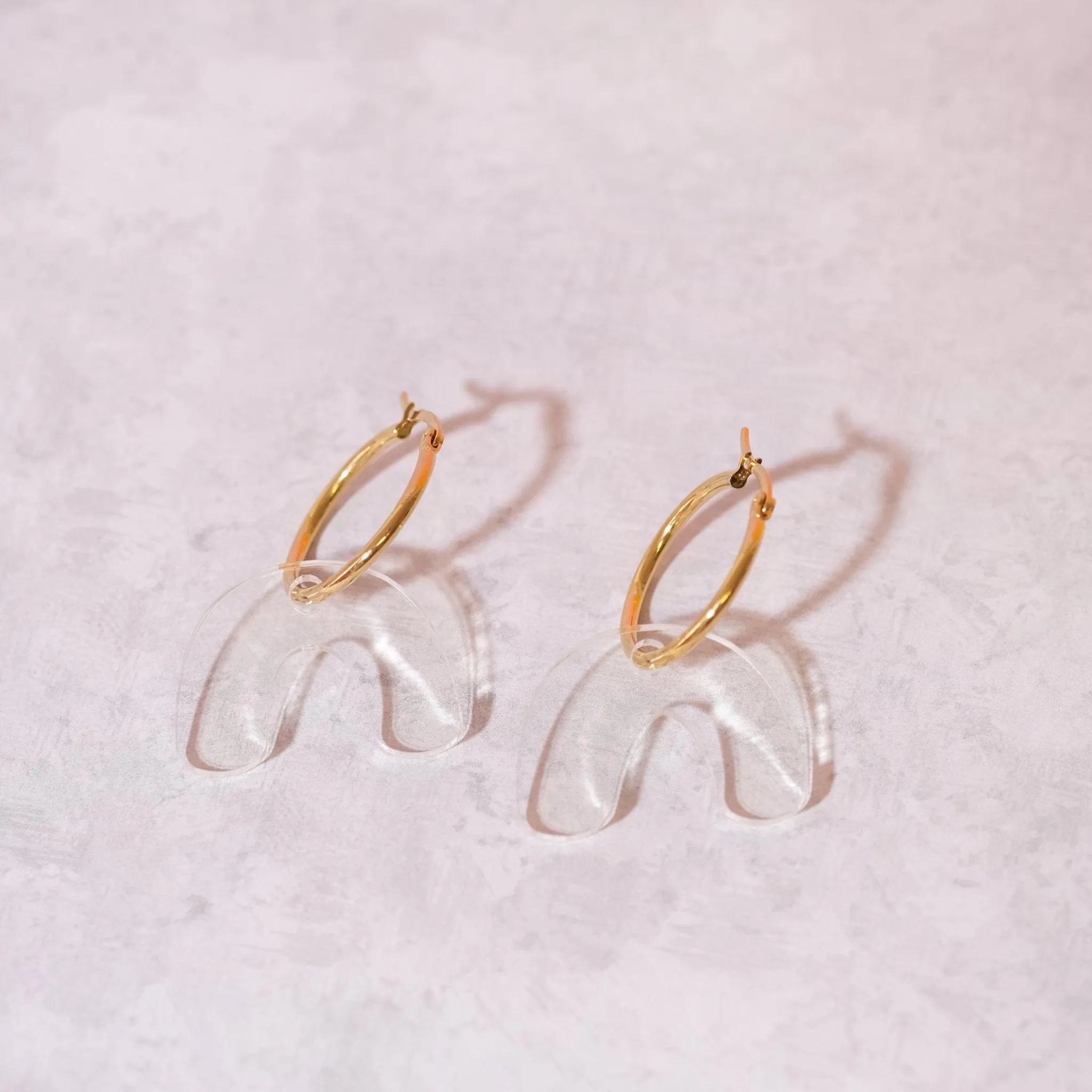 Clear arch hoop earrings